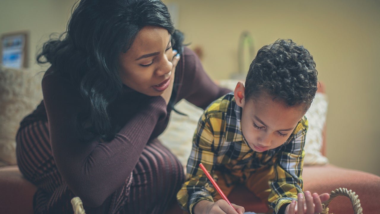 Preschool boy with his mother doing homework